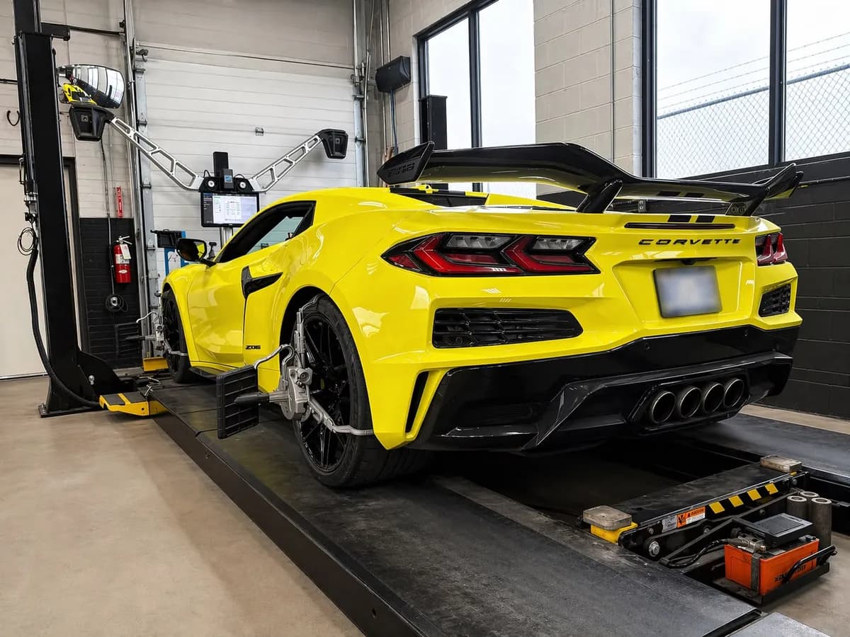 A car sitting on a wheel alignment rack