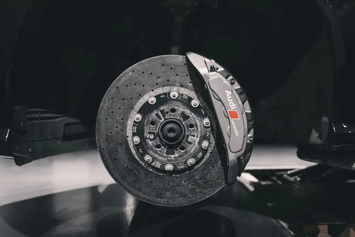 A brake caliper and rotor with the wheel removed